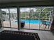 View from the sunroom of the screened-in in-ground pool and patio, with lounge chairs at 11651 Sw 77Th Cir, Ocala, FL 34476