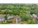 Aerial view of the property, showcasing the house, shed, and wooded surroundings at 13102 Se 101St Ave, Belleview, FL 34420