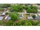 Aerial view of the property, including the house and neighborhood surrounded by lush greenery at 13102 Se 101St Ave, Belleview, FL 34420