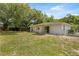 A house with a spacious backyard featuring a covered patio, and chain link fence at 13102 Se 101St Ave, Belleview, FL 34420