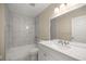 Bathroom featuring stylish white marble tiling, a new vanity, and modern fixtures at 13102 Se 101St Ave, Belleview, FL 34420