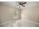 Bedroom featuring marble tile floors, a ceiling fan, and a bright window at 13102 Se 101St Ave, Belleview, FL 34420
