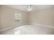 Spacious bedroom featuring marble tile floors, a ceiling fan, and a bright window at 13102 Se 101St Ave, Belleview, FL 34420