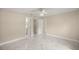 Bright bedroom with marble floors, ceiling fan, and access to bathroom and closet at 13102 Se 101St Ave, Belleview, FL 34420