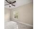 Bedroom featuring marble tile floors, a ceiling fan, and a bright window at 13102 Se 101St Ave, Belleview, FL 34420