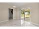 Open-concept living area with white marble floors, leading to outdoor access at 13102 Se 101St Ave, Belleview, FL 34420