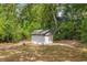 Small white outbuilding in a sunny backyard at 13102 Se 101St Ave, Belleview, FL 34420