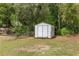Outbuilding in the backyard with white aluminum siding and a double door at 13102 Se 101St Ave, Belleview, FL 34420