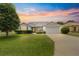 Charming single-Gathering home with manicured lawn, mature trees, and an attached two car garage at 1402 Arredondo Dr, The Villages, FL 32162