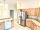 A clean kitchen featuring stainless steel appliances, ample cabinetry, and light-colored countertops at 1402 Arredondo Dr, The Villages, FL 32162
