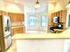 View of a kitchen with stainless steel appliances and breakfast bar that opens to a sunny breakfast nook at 1402 Arredondo Dr, The Villages, FL 32162