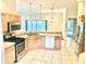 A clean kitchen featuring stainless steel appliances, and a seamless view of the light-filled living space at 1402 Arredondo Dr, The Villages, FL 32162