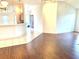 Bright living room featuring hardwood floors with an open floor plan to kitchen at 1402 Arredondo Dr, The Villages, FL 32162