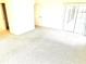 Carpeted living room featuring sliding glass doors for access to outside at 1402 Arredondo Dr, The Villages, FL 32162