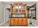 Elegant bar area with upper glass cabinets and ample storage at 1427 Sw 161St St, Ocala, FL 34473