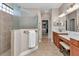 Elegant bathroom with tiled shower, glass partition, double sink and vanity at 1427 Sw 161St St, Ocala, FL 34473