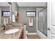 Bathroom with granite countertop, fixtures, and glass-door shower at 1427 Sw 161St St, Ocala, FL 34473