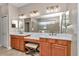 Bright bathroom featuring a large mirror, double sinks, and walk-in shower at 1427 Sw 161St St, Ocala, FL 34473