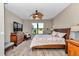 Spacious bedroom with ceiling fan, dresser, television, and nice view at 1427 Sw 161St St, Ocala, FL 34473