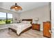 Comfortable bedroom featuring a ceiling fan, wood floors, and dresser at 1427 Sw 161St St, Ocala, FL 34473