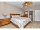 Well-lit bedroom featuring wood floors, ceiling fan, and an ensuite bathroom at 1427 Sw 161St St, Ocala, FL 34473
