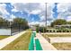 Community featuring tennis, shuffleboard, and horseshoe courts with lush landscaping and shade structures under a beautiful sky at 1427 Sw 161St St, Ocala, FL 34473