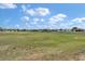 Scenic community view with open green space and homes under a blue sky with fluffy white clouds at 1427 Sw 161St St, Ocala, FL 34473