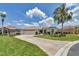 Beautifully landscaped home featuring a curved driveway, palm trees, and attached garage at 1427 Sw 161St St, Ocala, FL 34473