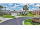 Charming home with well-manicured lawn, curved driveway, attached garage, and mature palm trees at 1427 Sw 161St St, Ocala, FL 34473