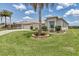 Well-maintained home featuring lush lawn, mature palm trees, and manicured landscaping at 1427 Sw 161St St, Ocala, FL 34473