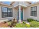 Close-up of the front entrance, highlighting the blue door, garden, and charming fountain at 1427 Sw 161St St, Ocala, FL 34473