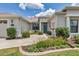 Inviting front entrance with a well-maintained garden, charming fountain, and bright blue door at 1427 Sw 161St St, Ocala, FL 34473