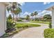 Beautifully landscaped front yard with flowering plants, a well-manicured lawn, and palm trees at 1427 Sw 161St St, Ocala, FL 34473