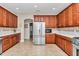 Spacious kitchen features stainless steel appliances, custom cabinets and tile backsplash at 1427 Sw 161St St, Ocala, FL 34473