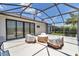 Open lanai features seating, a beautiful garden view and sliding glass doors at 1427 Sw 161St St, Ocala, FL 34473