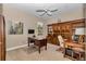 Traditional office space features a ceiling fan, ample desk space, and built-in shelving units for storage and organization at 1427 Sw 161St St, Ocala, FL 34473