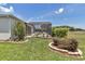 Enclosed screened porch featuring seating and landscaped yard with healthy green grass at 1427 Sw 161St St, Ocala, FL 34473