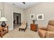Bright sitting room showcases a comfortable chair, side table, and views into other rooms for seamless entertaining at 1427 Sw 161St St, Ocala, FL 34473