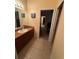Cozy bathroom featuring a single sink vanity with tile flooring and neutral decor at 15011 Sw 61St Court Rd, Ocala, FL 34473