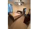 Bedroom with a bed, ceiling fan, window, and a view to the doorway at 15011 Sw 61St Court Rd, Ocala, FL 34473