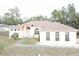 An aerial view of a peach-colored single-Gathering home with a well-maintained lawn at 15011 Sw 61St Court Rd, Ocala, FL 34473