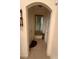 Hallway features an arched entry and tile flooring, leading to rooms on either side at 15011 Sw 61St Court Rd, Ocala, FL 34473
