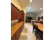Open kitchen view with bar stool seating and wooden cabinets at 15011 Sw 61St Court Rd, Ocala, FL 34473