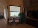 Cozy seating area with a large window, a comfortable seating arrangement, and serene outdoor views at 15011 Sw 61St Court Rd, Ocala, FL 34473
