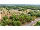 Expansive aerial view of a rural property featuring lush greenery and several structures in a serene countryside setting at 15465 Se 113Th Street Rd, Ocklawaha, FL 32179
