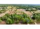 Wide aerial shot displaying the property's boundary, surrounded by verdant trees and distant rural dwellings at 15465 Se 113Th Street Rd, Ocklawaha, FL 32179