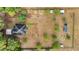 Aerial view of a secluded property with a home and outbuildings, surrounded by open land and trees at 15465 Se 113Th Street Rd, Ocklawaha, FL 32179