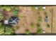 Aerial view of a secluded property with a home and outbuildings, surrounded by open land and trees at 15465 Se 113Th Street Rd, Ocklawaha, FL 32179