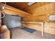 A barn interior with wood walls, roll-up door, utility table and concrete floors at 15465 Se 113Th Street Rd, Ocklawaha, FL 32179