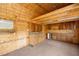 Inside a barn with wood walls, a concrete floor, cabinets and countertop for utility at 15465 Se 113Th Street Rd, Ocklawaha, FL 32179